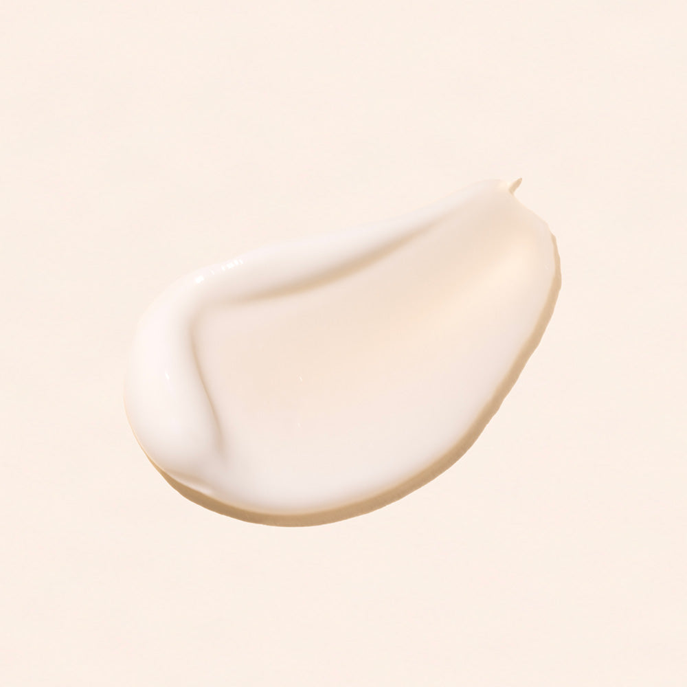 Close-up of a smooth day night cream natural face moisturizer by rachel perry skincare on a light beige background