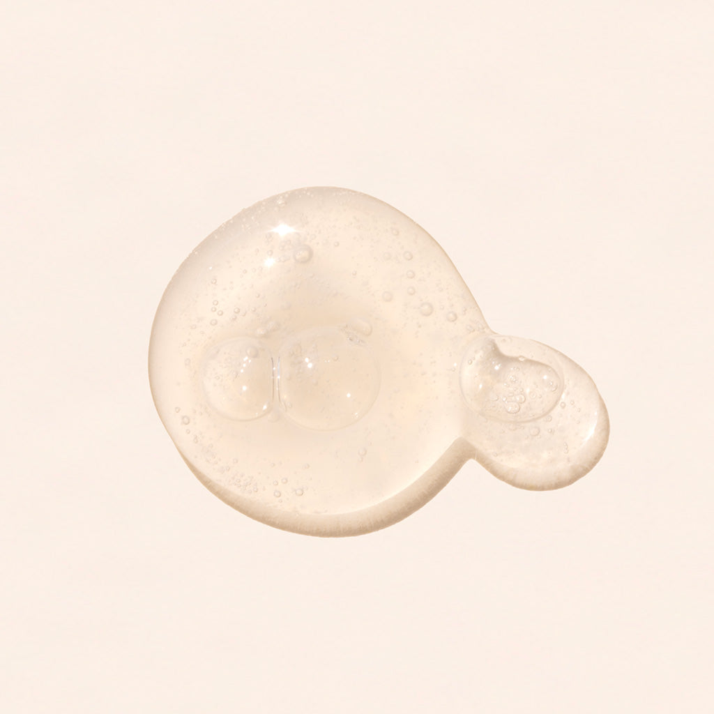 all natural clean hydrating face serum liquid droplet on a light pink background celestial glow rejuvenating serum by rachel perry