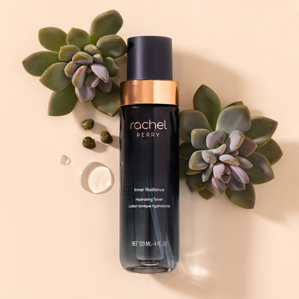 Skincare bottle labeled rachel perry inner radiance hydrating toner with succulents on a beige background