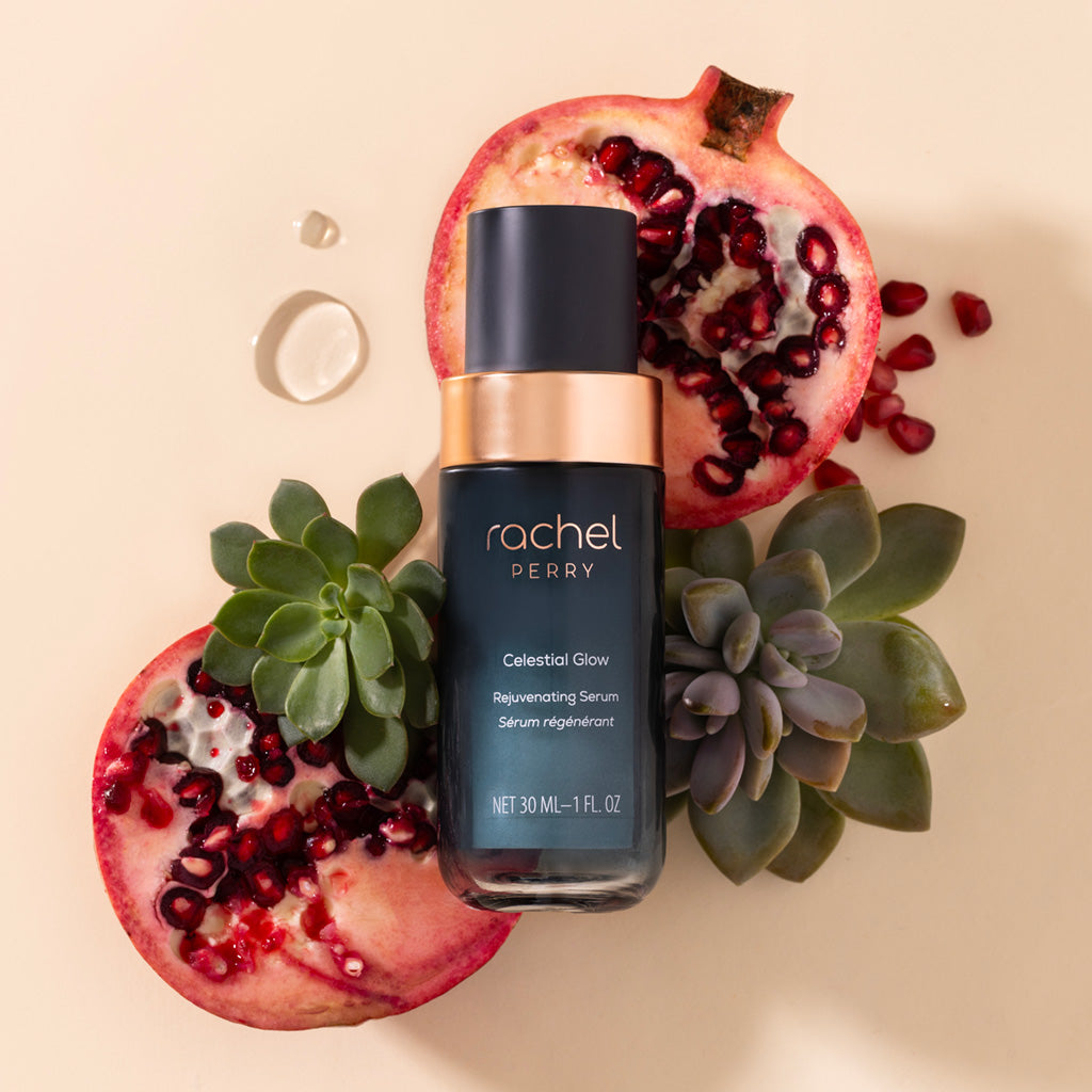 serum bottle labeled celestial glow rejuvenating serum by rachel perry all natural clean skincare with pomegranate and succulents on a beige background