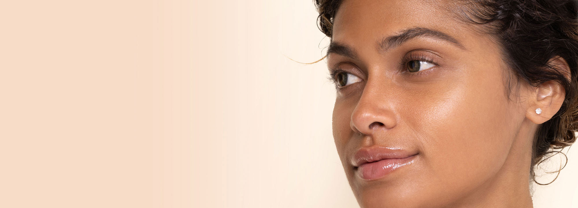 Close-up of a woman's face clean with rachel perry skincare with a neutral background