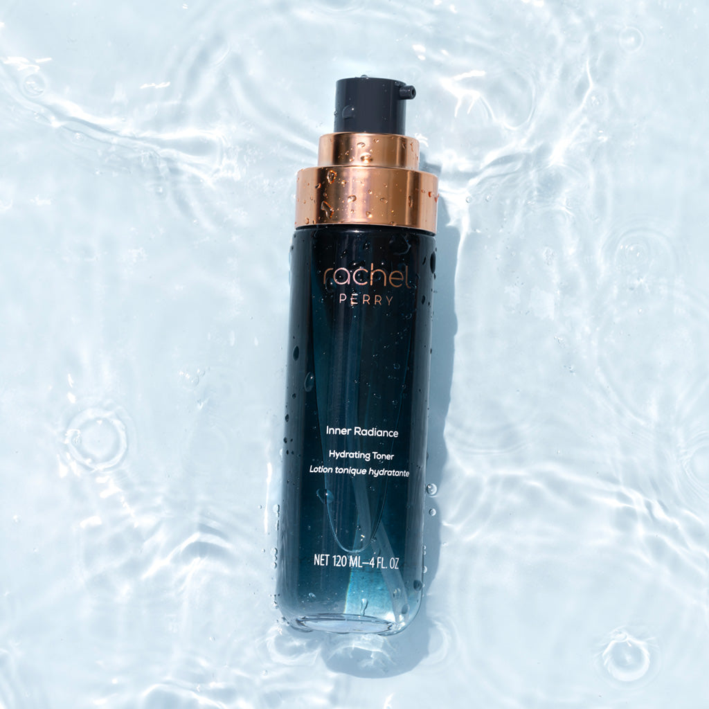 Bottle of inner radiance hydrating toner Rachel Perry natural clean skincare on a light blue water background