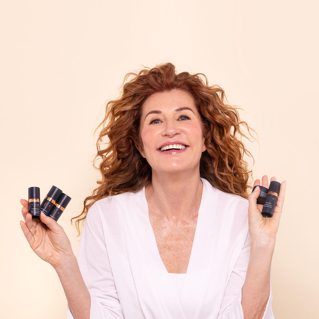woman holding rachel perry all natural skincare products in the travel mini sizes