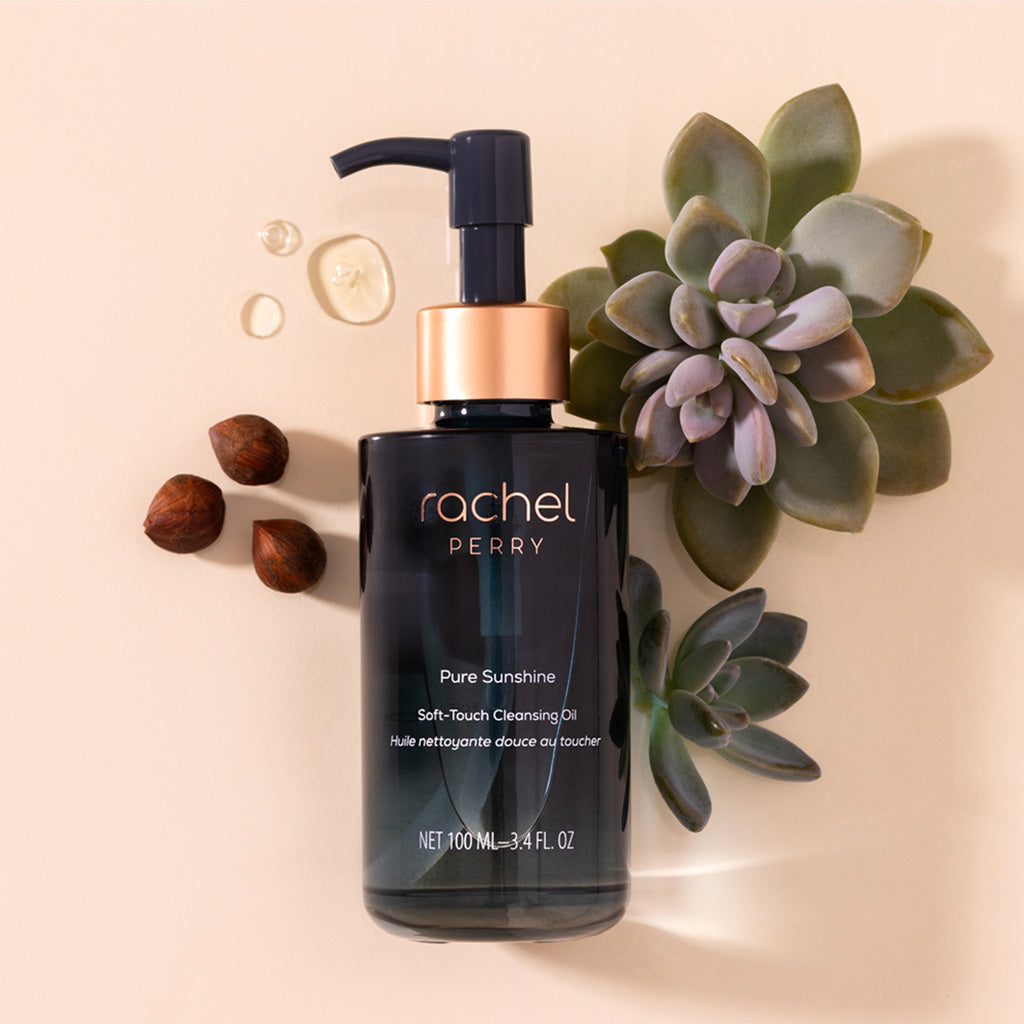 Rachel Perry natural Cleansing oil bottle with pump and succulent plant on a beige background